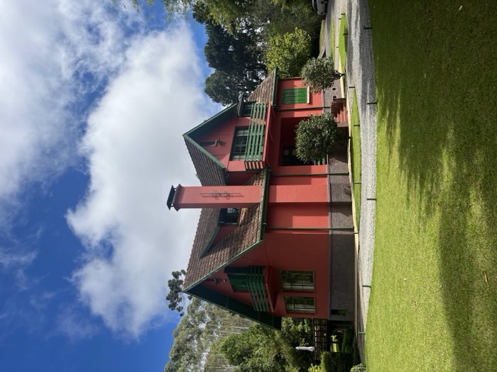 Casa principal e jardins sob céu azul